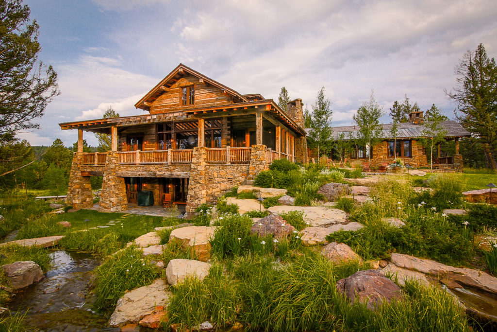 Photo of country home with stone retaining and natural plantings